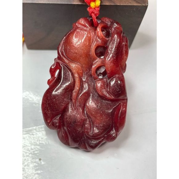 Red carved jade pendant